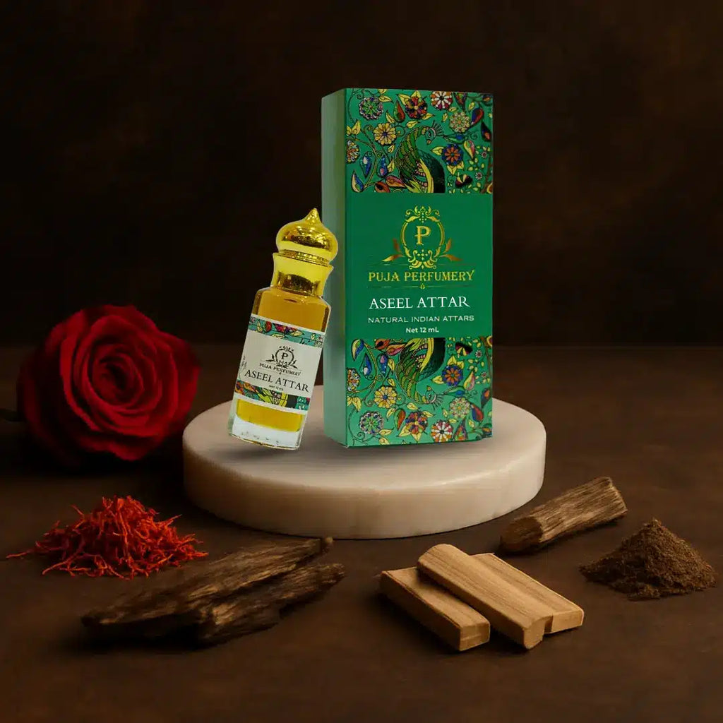 Puja Perfumery Aseel Attar bottle and packaging with a red rose and wooden sticks on a dark background