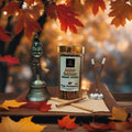 Amber Bakhoor Dhoop sticks with a bell and candles on a wooden tray, surrounded by autumn leaves.