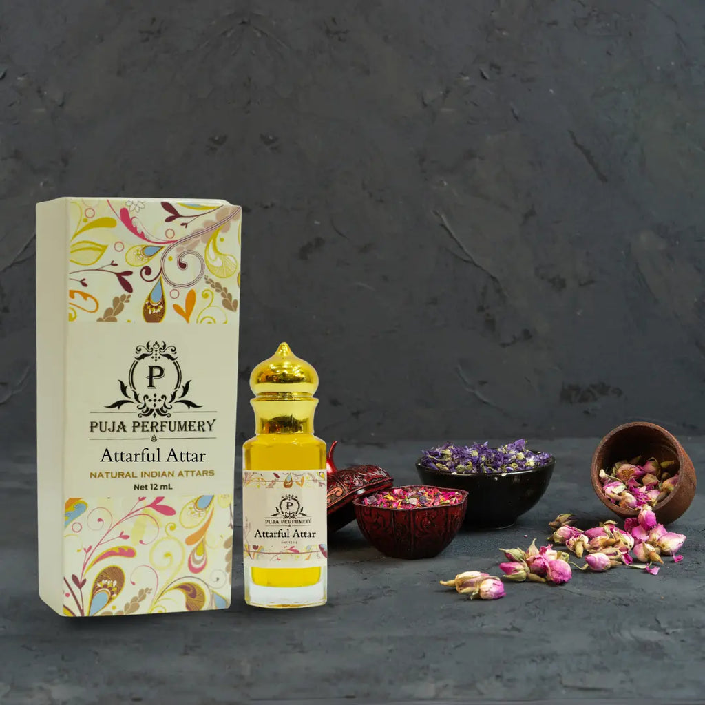 Puja Perfumery Attarful Attar bottle and packaging on a dark background with dried flowers.