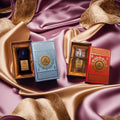 Two perfume bottles in decorative boxes on a luxurious fabric background
