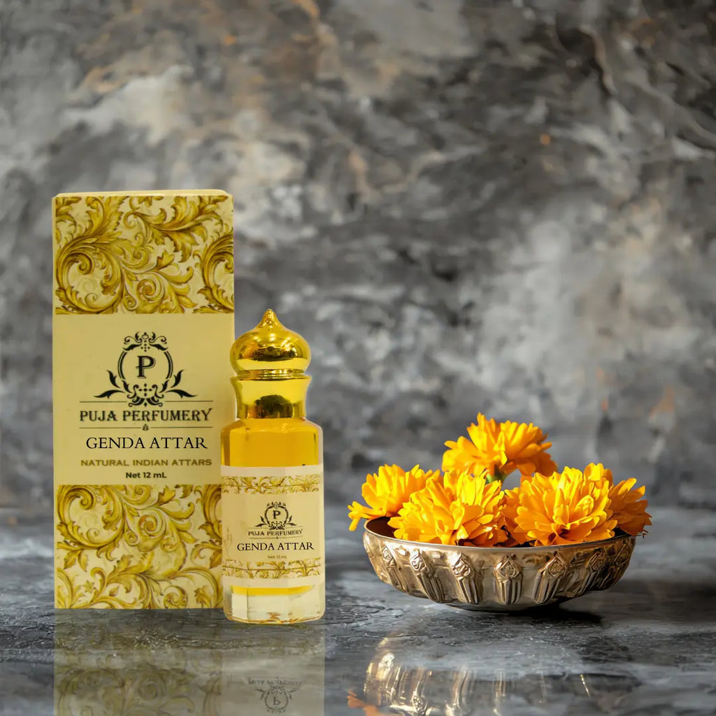 Puja Perfumery Genda Attar bottle and packaging with yellow flowers on a reflective surface.