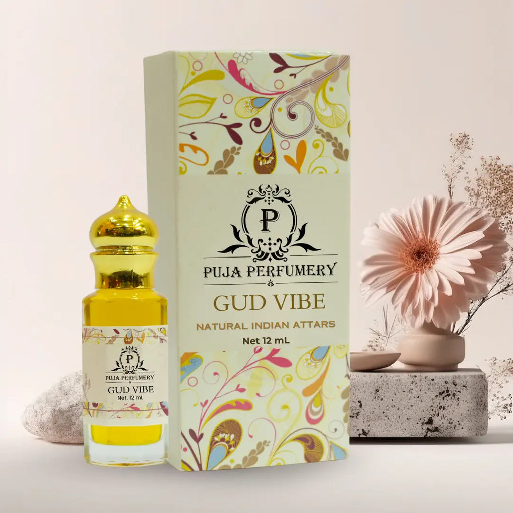 Puja Perfumery Gud Vibe perfume bottle and packaging with a decorative flower on a light background