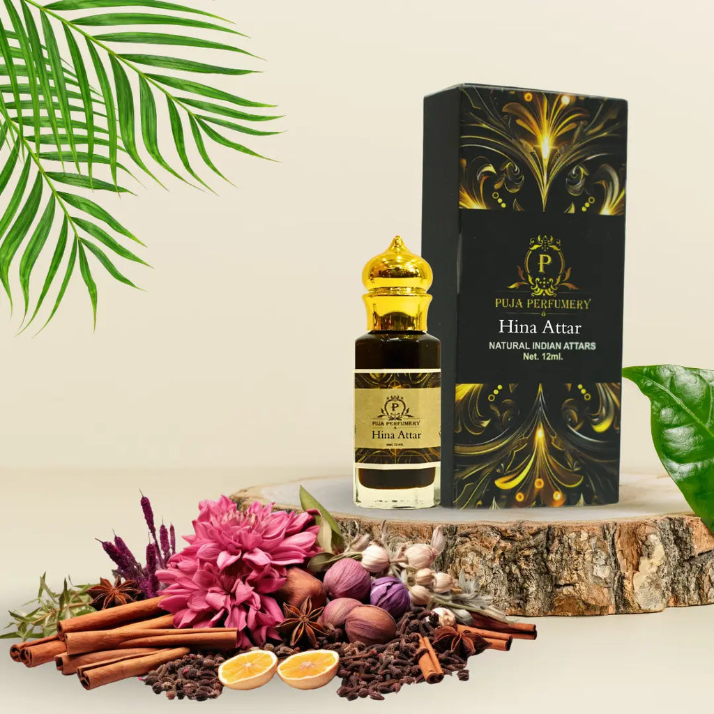 Puja Perfumery Hina Attar bottle and packaging with flowers and spices on a wooden surface.
