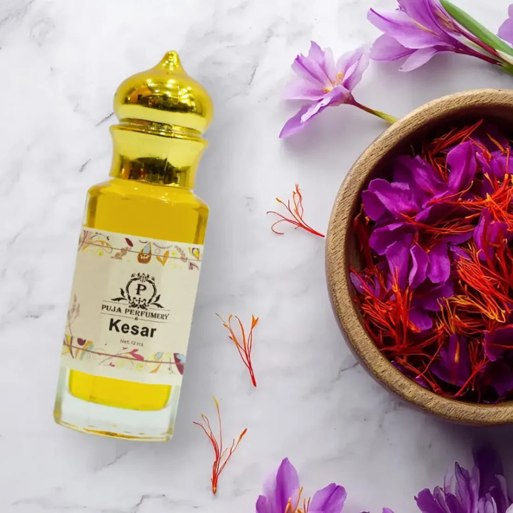 Puja Kesar perfume bottle with saffron and flowers on a marble background