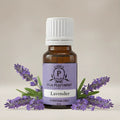 Lavender essential oil bottle with lavender flowers on a beige background