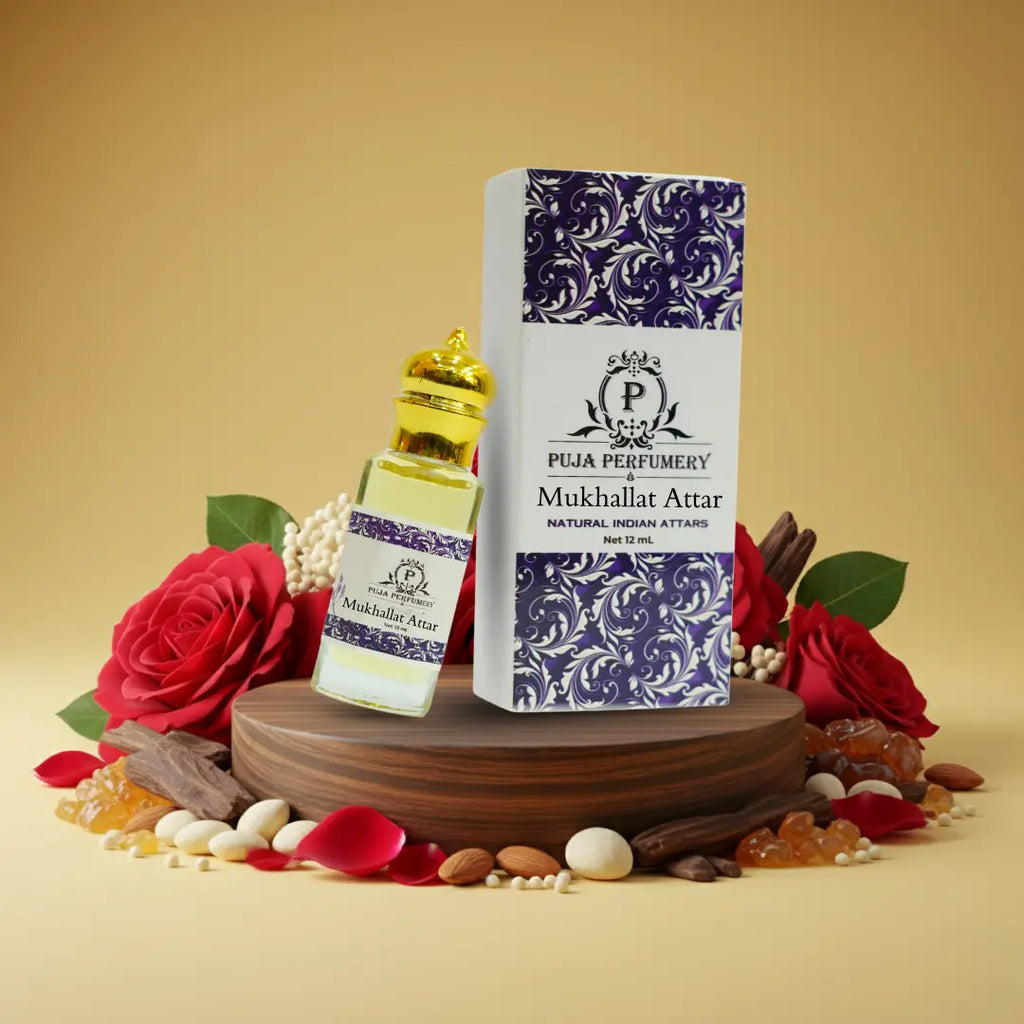 Puja Perfumery Mukhallat Attar with packaging on a wooden platform surrounded by flowers and spices.
