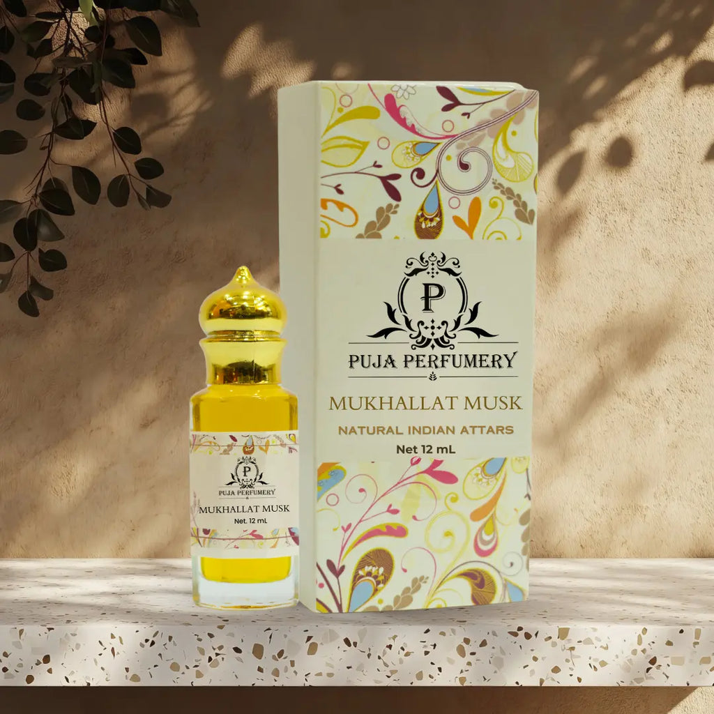 Puja Perfumery Mukhallat Musk perfume bottle and packaging on a wooden surface with a beige background.