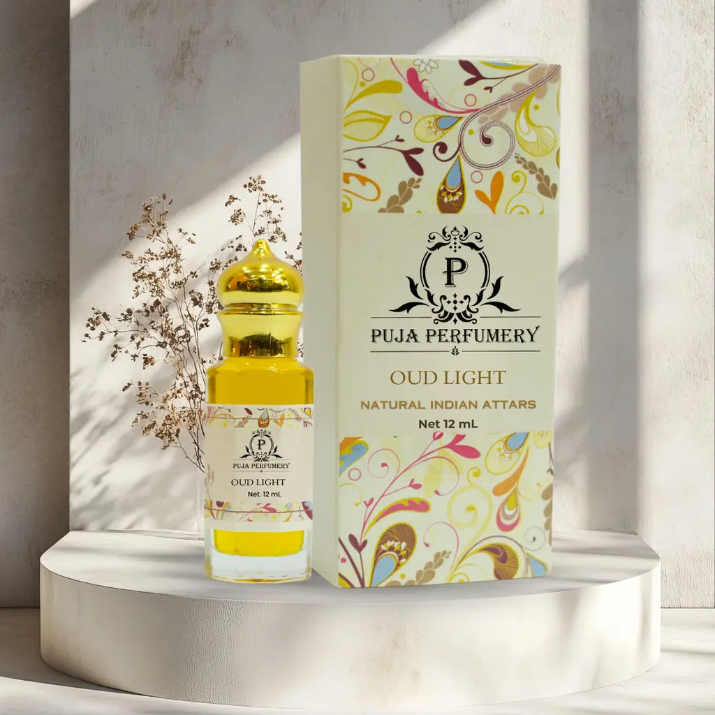 Puja Perfumery Oud Light perfume bottle and packaging on a decorative stand with a neutral background