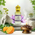 Bottle of Oud Light perfume with oranges, purple flowers, and a fire bowl on a white background