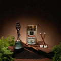 Oudh Dhoop Sticks with a traditional incense holder on a wooden platform with a dark background