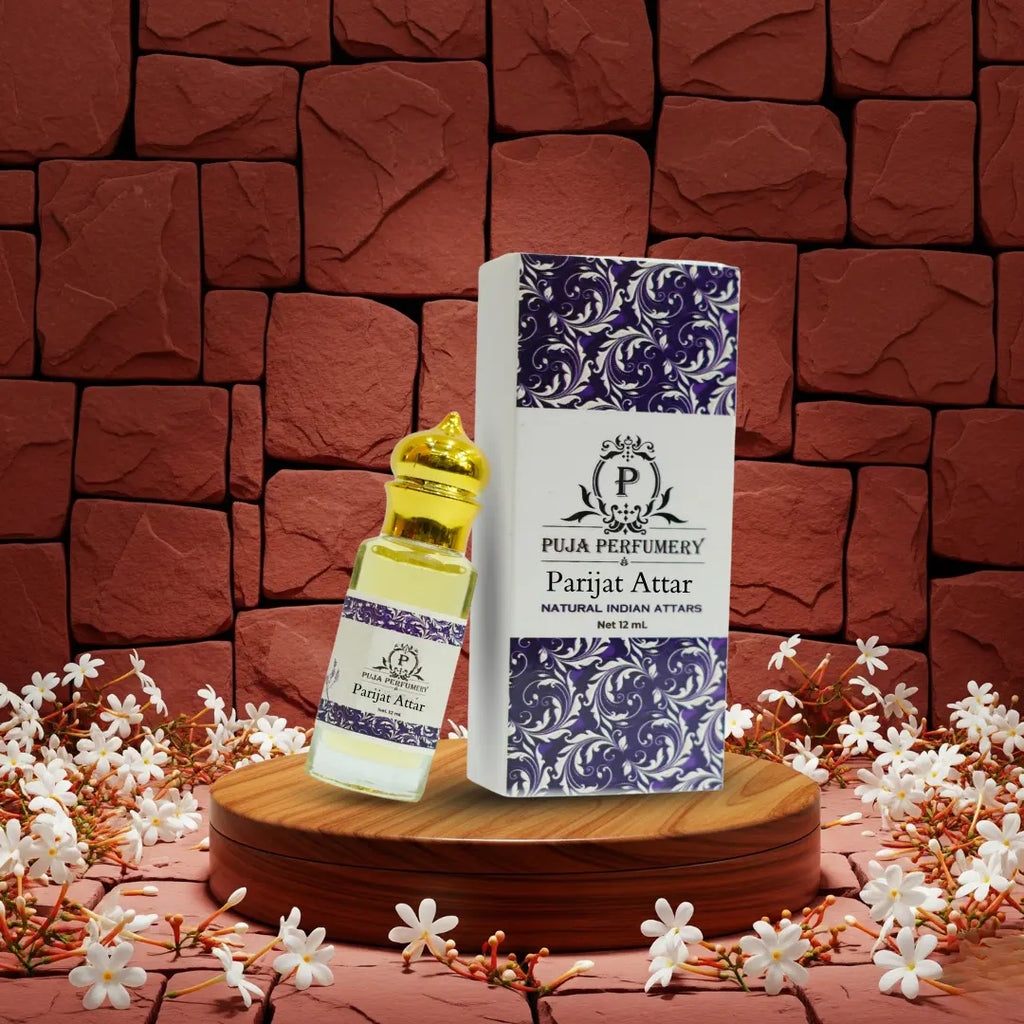 Puja Perfumery Parijat Attar bottle and packaging on a wooden stand with a floral background.