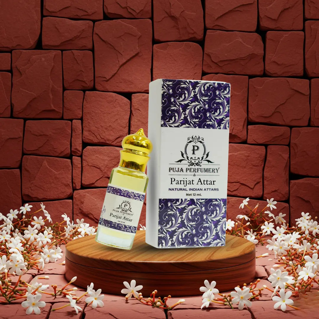 Puja Perfumery Parijat Attar bottle and packaging on a wooden stand with a floral background.