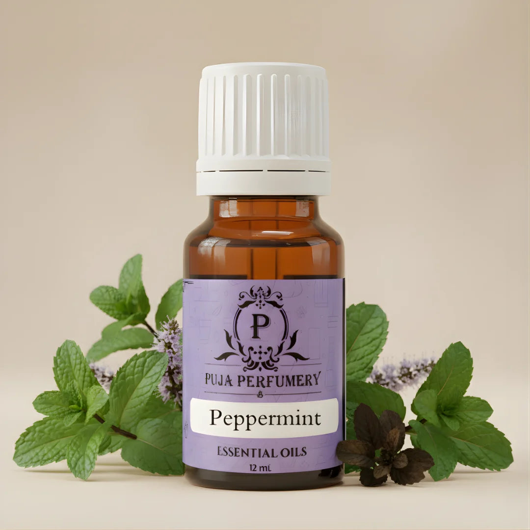 Bottle of Puja Perfumery Peppermint essential oil with peppermint leaves on a beige background