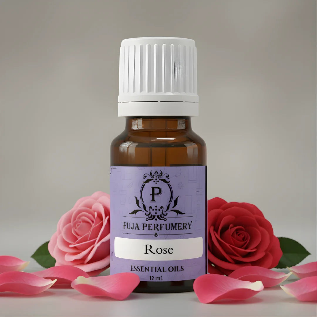 Bottle of Puja Perfumery Rose essential oil with two roses and petals on a light background