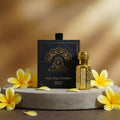 Puja Perfumery Ruh Nag Champa pure oil bottle and packaging with yellow flowers on a stone surface.