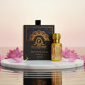 Pulia Perfumery Ruh Pink Lotus pure oil bottle and packaging on a marble surface with pink lotus flowers.