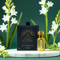 Puja Perfumery Ruh Rajnigandha pure oil bottle and packaging with white flowers in the background