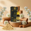 Perfume bottle with packaging and sandalwood on a wooden stand with flowers around