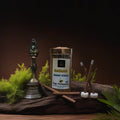 Sandalwood dhoop sticks with a traditional bell and greenery on a dark background