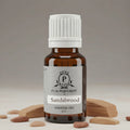 Sandalwood essential oil bottle with a white cap on a neutral background