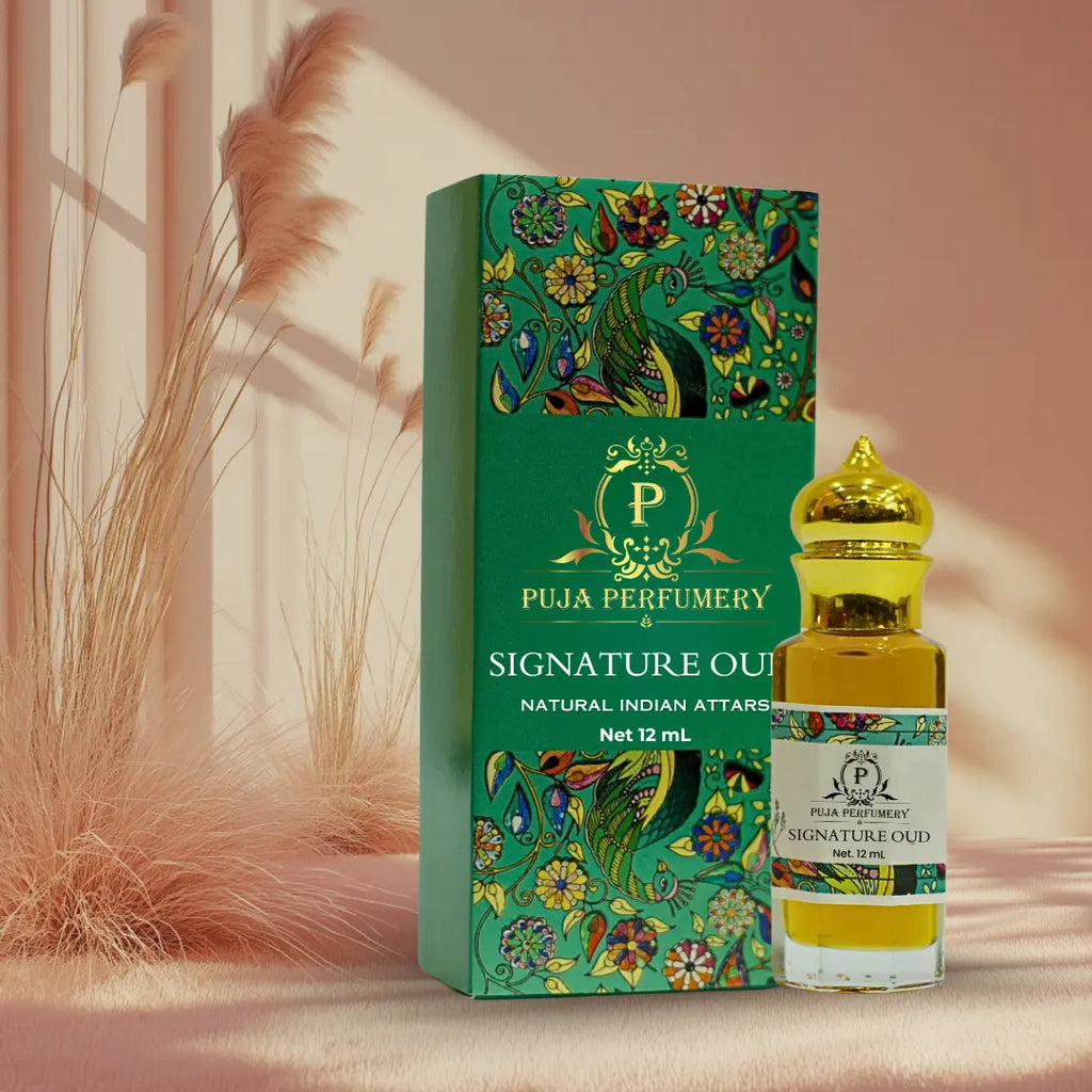 Puja Perfumery Signature Oud perfume bottle and packaging on a soft pink background
