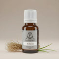 Bottle of Vetiver essential oil with a white cap on a beige background