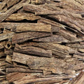 Close-up of stacked agarwood chips with a natural brown color.