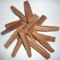 sandalwood logs arranged in a star-like pattern on a white background
